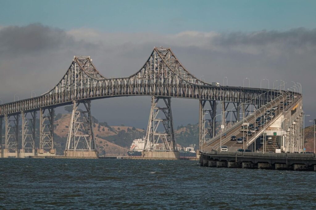 The Richmond–San Rafael Bridge with vehicles crossing westbound and the Bay waters below.