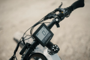 Electric bicycle handlebar display showing speed and battery information on an e-bike