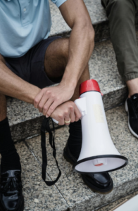 Person holding a megaphone representing public debate over California e-bike legislation